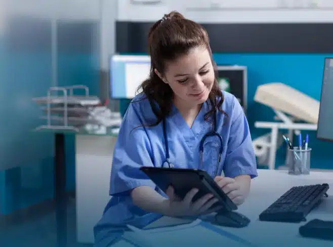 A medical nurse filling information in a tablet